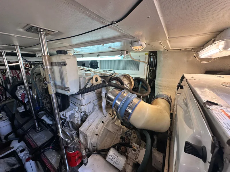 Slide: The Image of Engine room of 2004 Grand Banks 49 Eastbay HX, showcasing mechanical components and systems. - 132