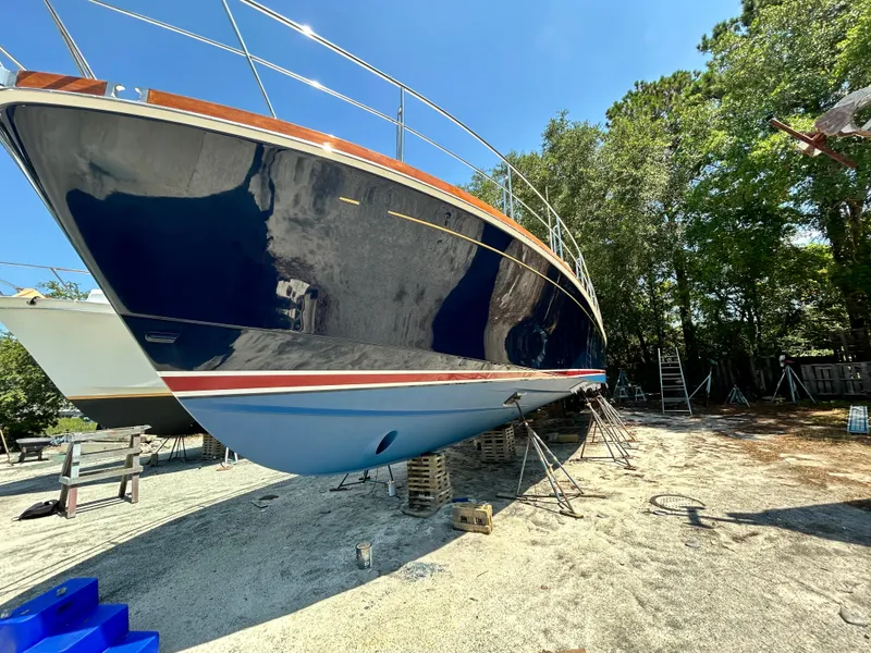 Slide: The Image of 2004 Grand Banks 49 Eastbay HX yacht on dry dock, blue hull, sunny day. - 19