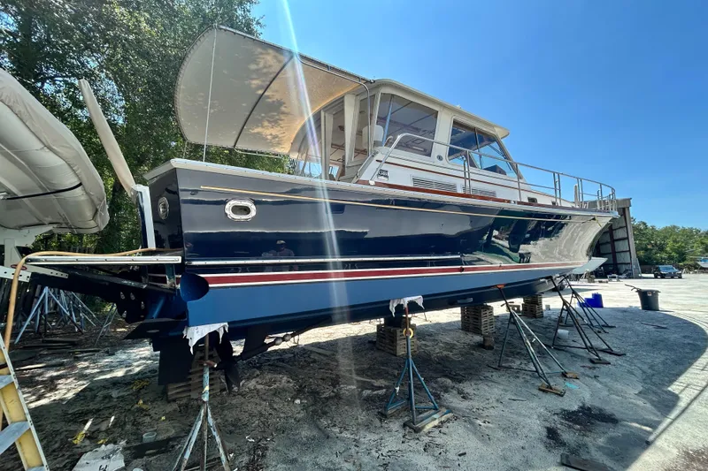 Slide: The Image of 2004 Grand Banks 49 Eastbay HX yacht on stands, outdoor setting, clear sky. - 20