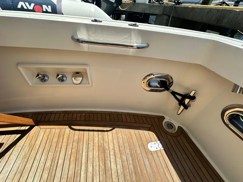 Slide: The Image of 2004 Grand Banks 49 Eastbay HX yacht deck with teak flooring and stainless steel fixtures. - 26