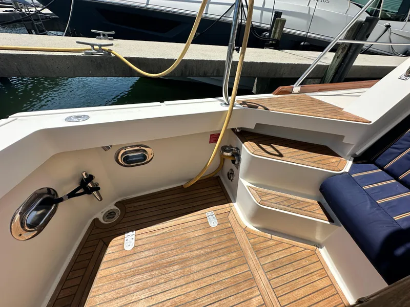 Slide: The Image of 2004 Grand Banks 49 Eastbay HX yacht with teak deck and cushioned seating. - 31