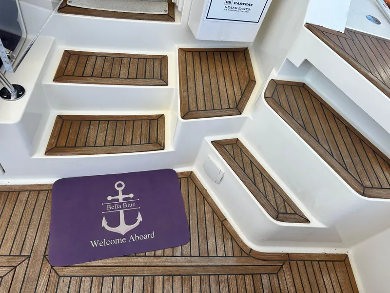 Slide: The Image of Teak steps and welcome mat on 2004 Grand Banks 49 Eastbay HX yacht. - 39