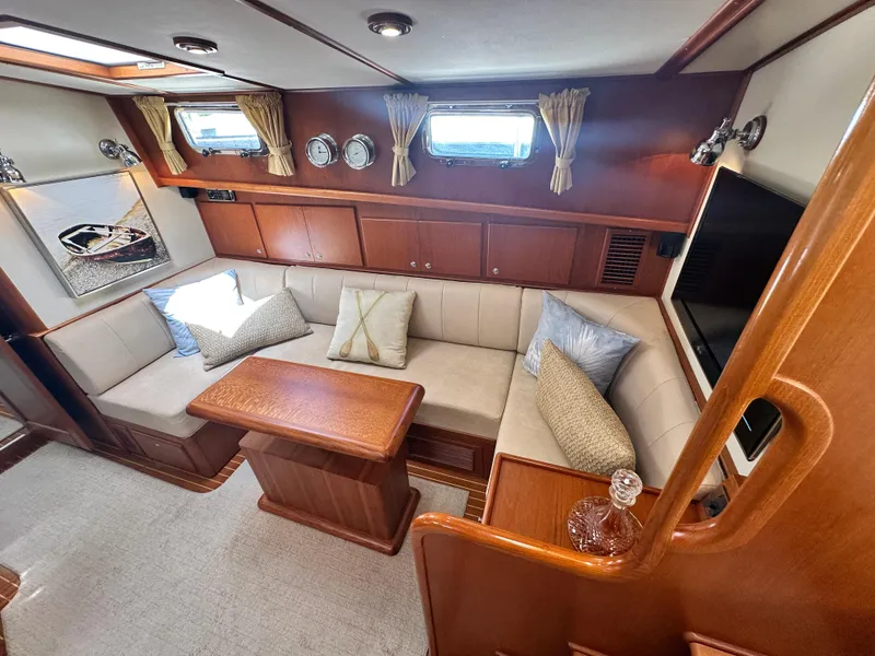 Slide: The Image of Luxurious 2004 Grand Banks 49 Eastbay HX yacht interior with plush seating and elegant wood finishes. - 42