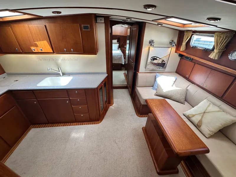 Slide: The Image of Luxurious interior of 2004 Grand Banks 49 Eastbay HX yacht with kitchen and seating area. - 43