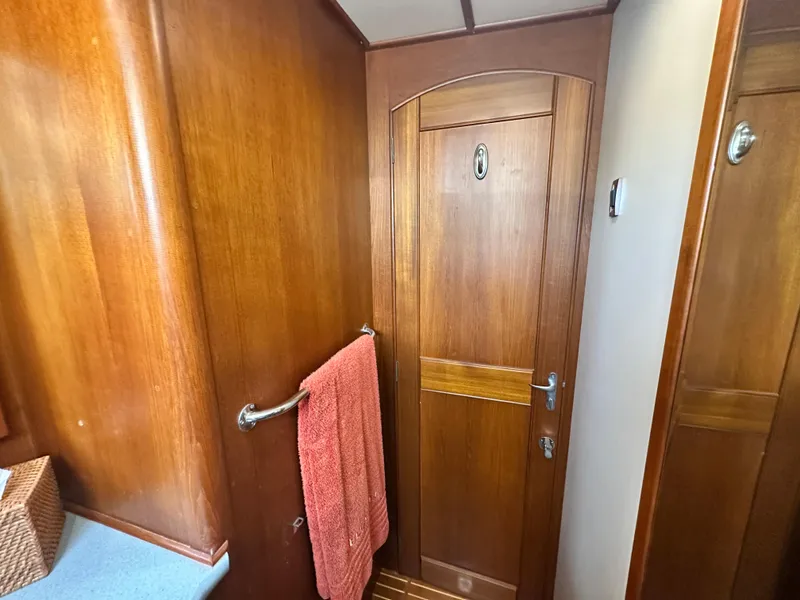 Slide: The Image of Wooden interior of 2004 Grand Banks 49 Eastbay HX yacht with towel and door. - 58