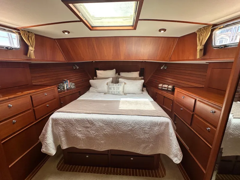 Slide: The Image of Luxurious 2004 Grand Banks 49 Eastbay HX cabin with elegant wood finish and cozy bedding. - 61