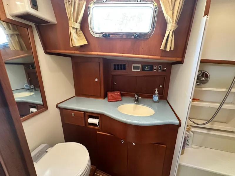 Slide: The Image of 2004 Grand Banks 49 Eastbay HX yacht bathroom with wood cabinetry and sink. - 64