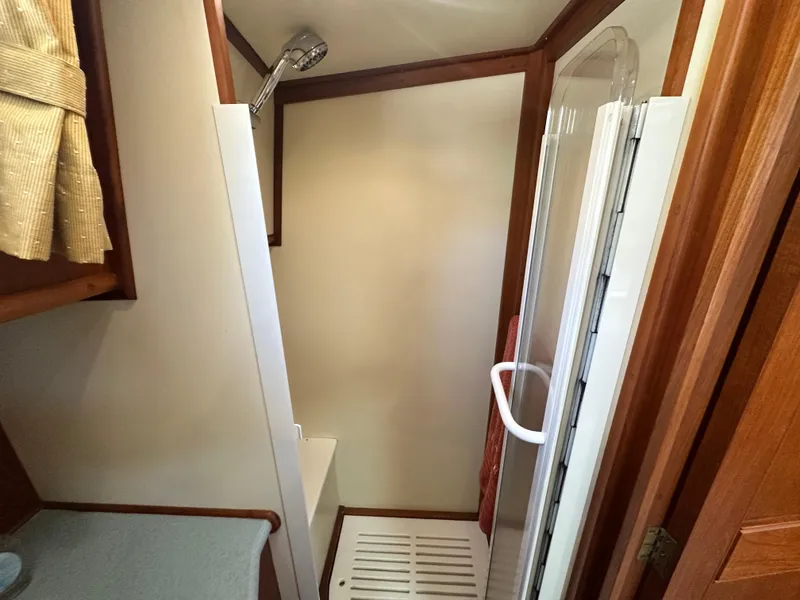 Slide: The Image of Shower area in 2004 Grand Banks 49 Eastbay HX yacht, featuring wood accents and modern fixtures. - 66