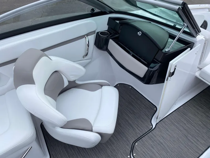 Slide: The Image of 2022 Four Winns HD2 Surf boat interior with white and gray seating and dashboard. - 11
