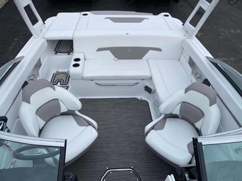 Slide: The Image of 2022 Four Winns HD2 Surf boat interior with white and gray seating. - 12