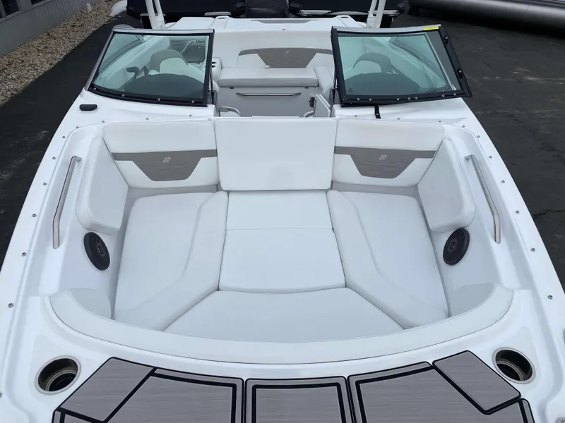 Slide: The Image of 2022 Four Winns HD2 Surf boat with spacious white seating and sleek design. - 17