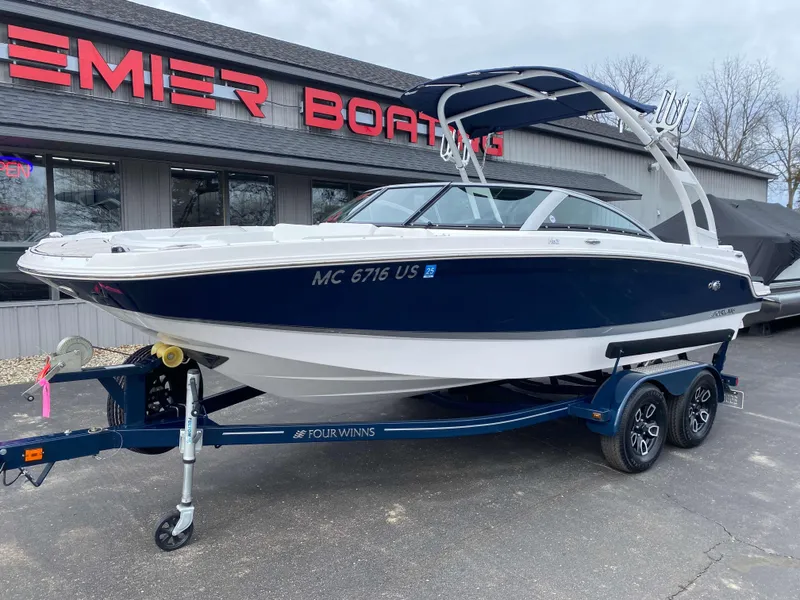 Slide: The Image of 2022 Four Winns HD2 Surf boat on trailer at Premier Boating dealership. - 18