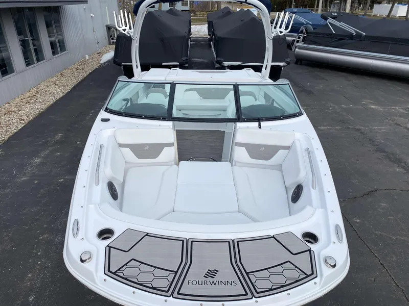 Slide: The Image of 2022 Four Winns HD2 Surf boat with sleek white interior and modern design. - 2