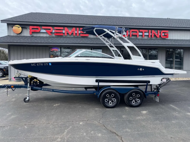 Slide: The Image of 2022 Four Winns HD2 Surf boat on trailer, parked outside dealership. - 20
