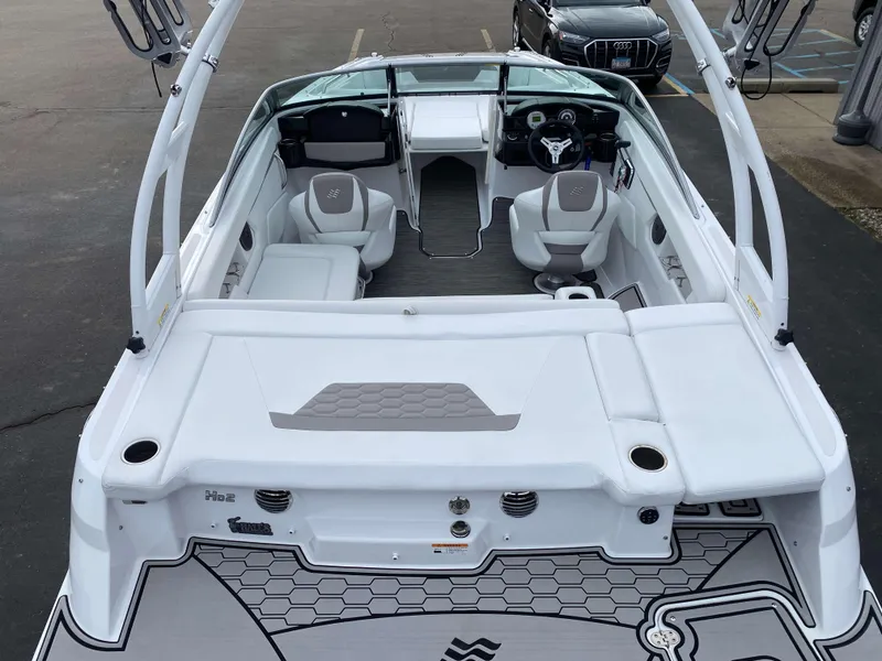 Slide: The Image of 2022 Four Winns HD2 Surf boat interior with seating and steering wheel, viewed from the rear. - 3
