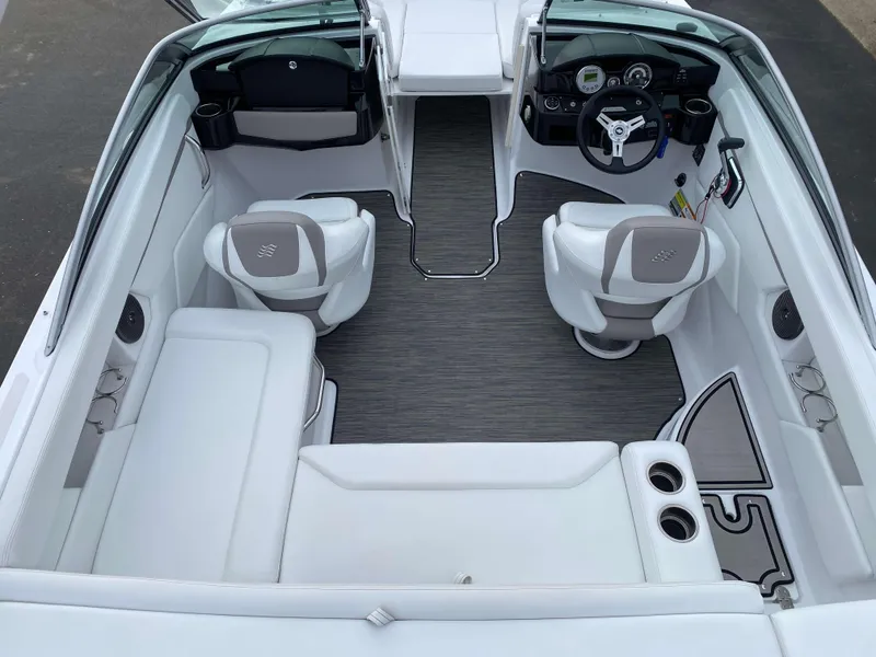 Slide: The Image of 2022 Four Winns HD2 Surf boat interior with white seating and modern dashboard. - 6
