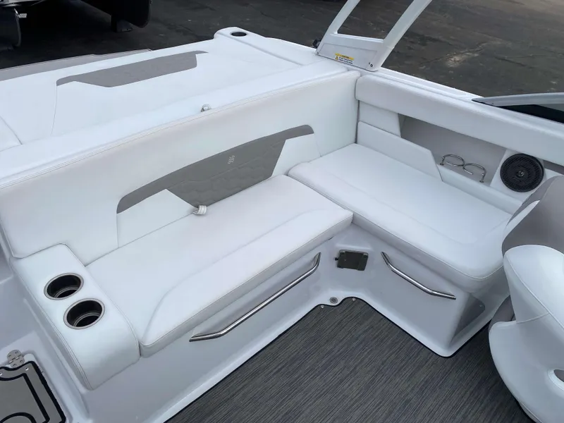 Slide: The Image of 2022 Four Winns HD2 Surf boat interior with white seating and cup holders. - 7