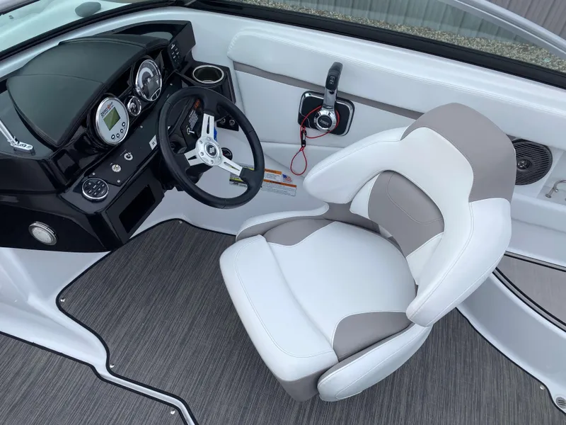 Slide: The Image of 2022 Four Winns HD2 Surf boat interior with steering wheel and captain's chair. - 8