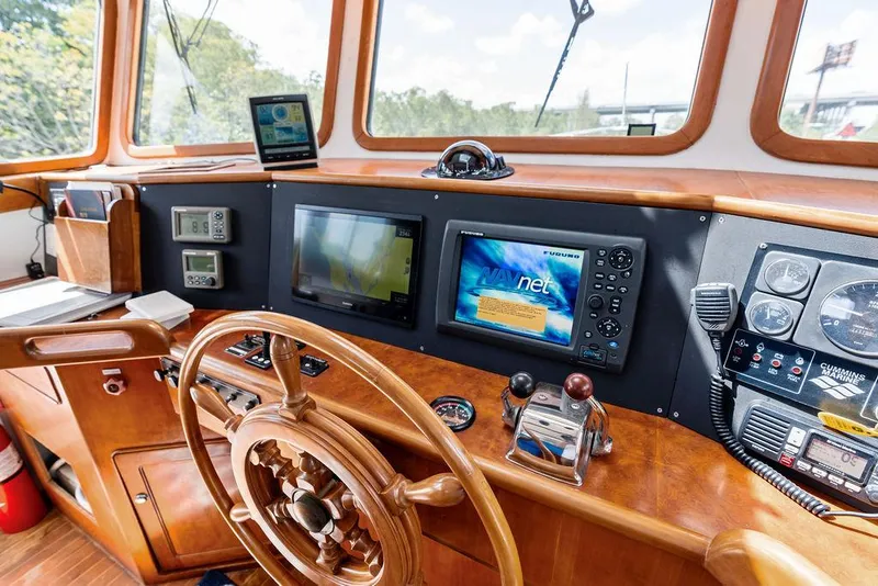 Slide: The Image of Wooden helm of 2000 Selene Solo boat with navigation screens and controls. - 15