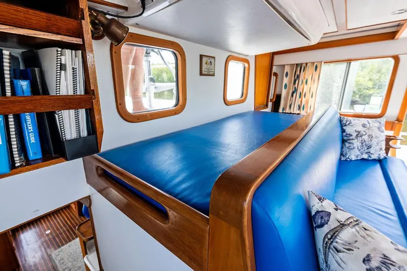 Slide: The Image of Cozy cabin interior of 2000 Selene Solo yacht with blue seating and wooden accents. - 19
