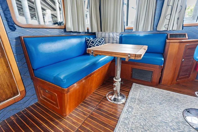 Slide: The Image of Interior of 2000 Selene Solo boat with blue seating and wooden table. - 23