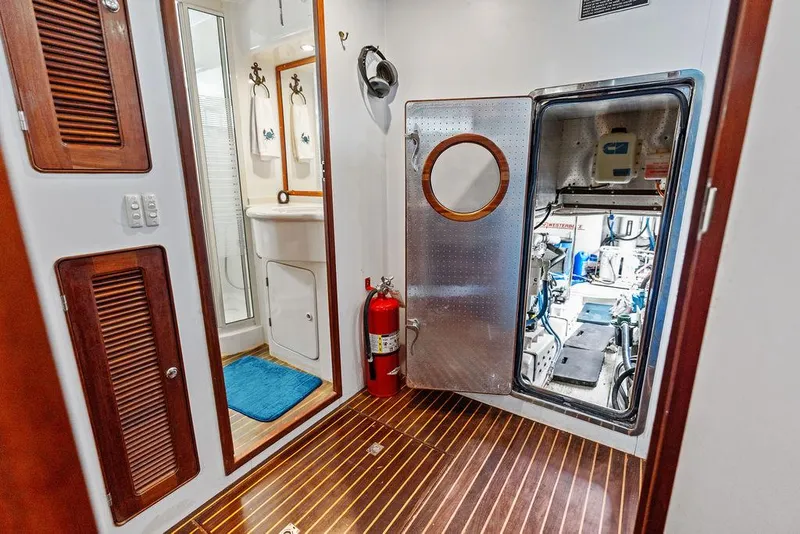 Slide: The Image of Engine room access on 2000 Selene Solo yacht, featuring wooden flooring and safety equipment. - 25