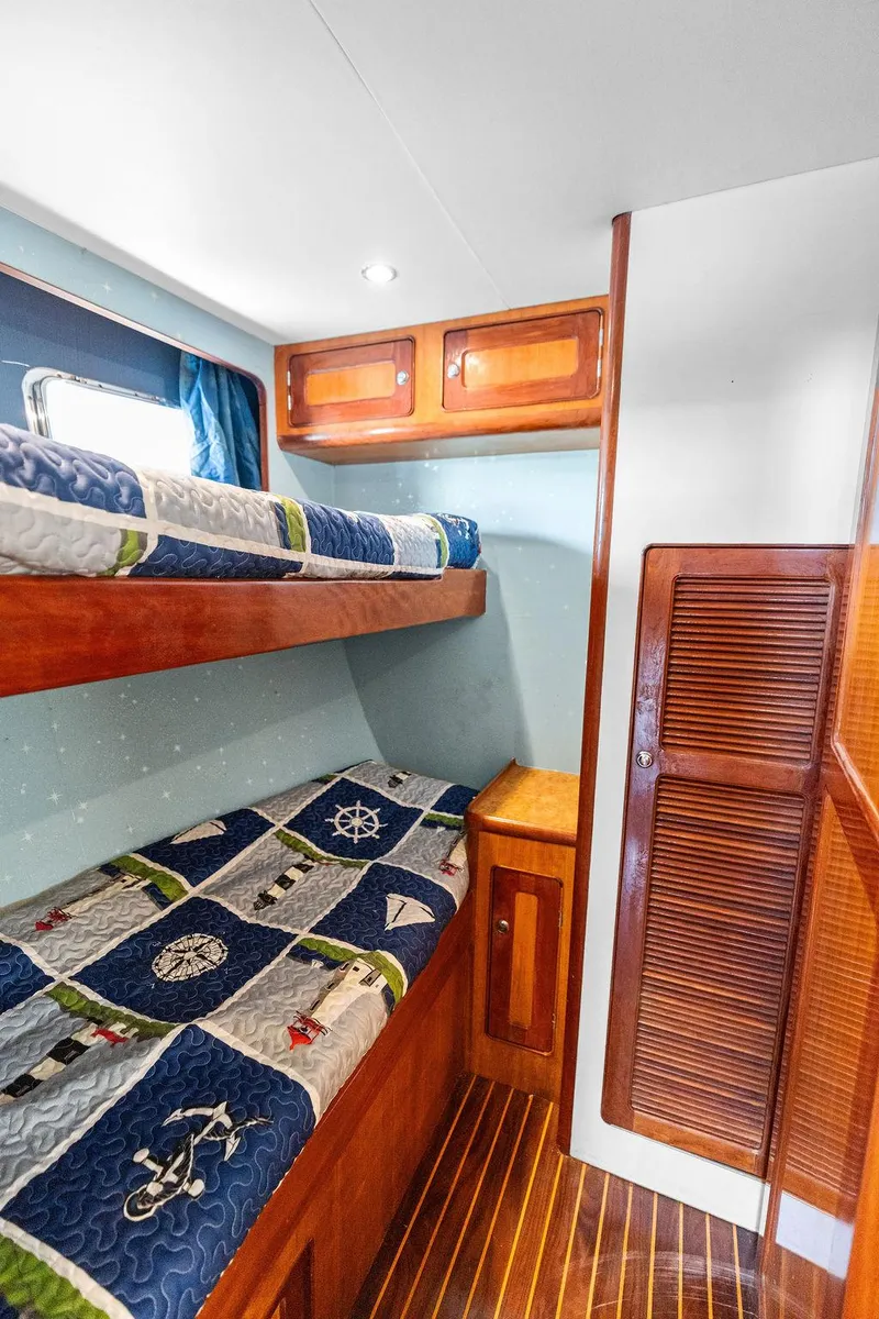Slide: The Image of Bunk beds in a 2000 Selene Solo yacht cabin with nautical-themed bedding. - 27