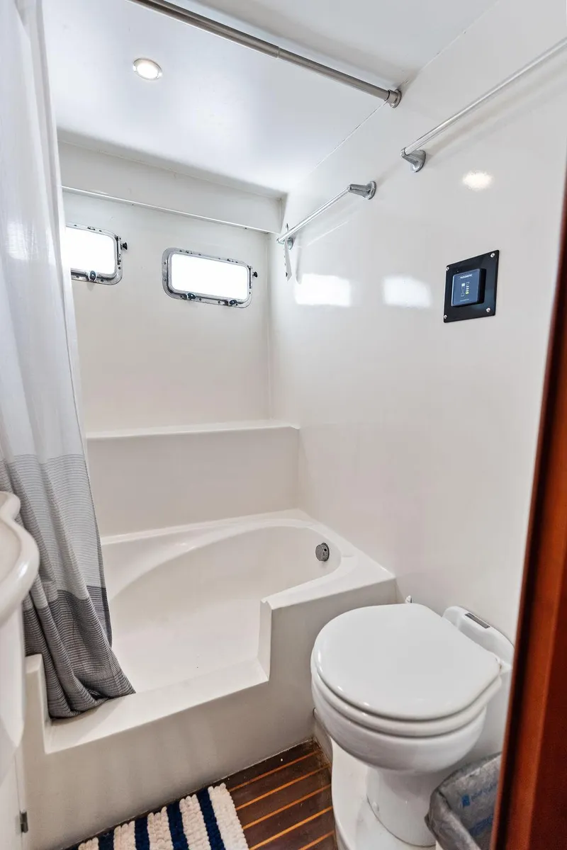 Slide: The Image of Compact bathroom in 2000 Selene Solo yacht with shower, toilet, and porthole windows. - 33