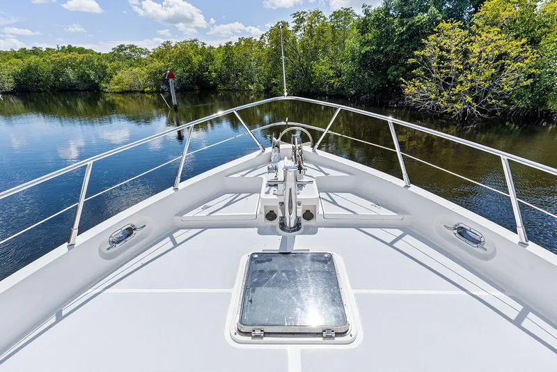 Slide: The Image of Bow view of 2000 Selene Solo yacht navigating a serene river with lush greenery. - 8