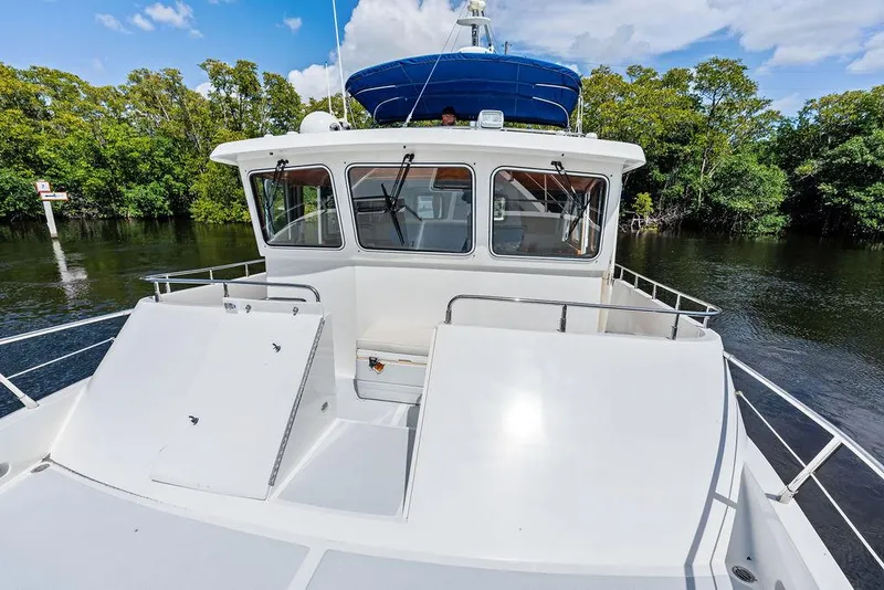 Slide: The Image of Selene Solo 2000 boat on calm water, surrounded by lush greenery and blue sky. - 9
