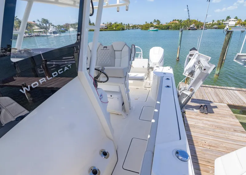 Slide: The Image of 2024 World Cat 260CC boat docked, showcasing sleek design and spacious seating. - 10