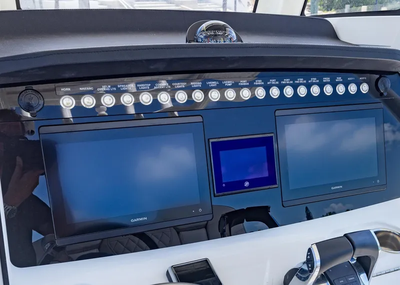 Slide: The Image of 2024 World Cat 260CC dashboard with dual Garmin screens and control panel. - 11