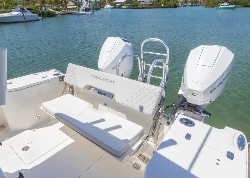 Slide: The Image of 2024 World Cat 260CC boat with dual engines, docked on a sunny day. - 16