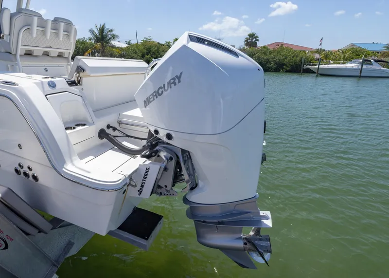 Slide: The Image of 2024 World Cat 260CC boat with Mercury outboard engine on calm water. - 2