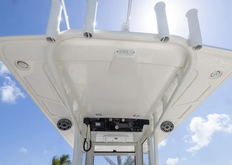 Slide: The Image of 2024 World Cat 260CC boat roof with rod holders and speakers under clear sky. - 20
