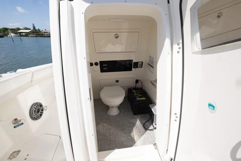 Slide: The Image of 2024 World Cat 260CC boat interior with toilet and storage compartment. - 21