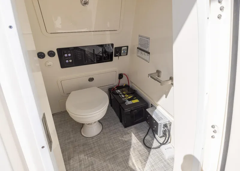 Slide: The Image of 2024 World Cat 260CC boat interior with toilet and battery setup. - 22