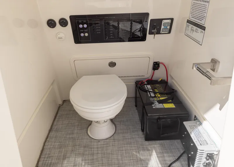 Slide: The Image of 2024 World Cat 260CC boat interior with toilet and control panel. - 23