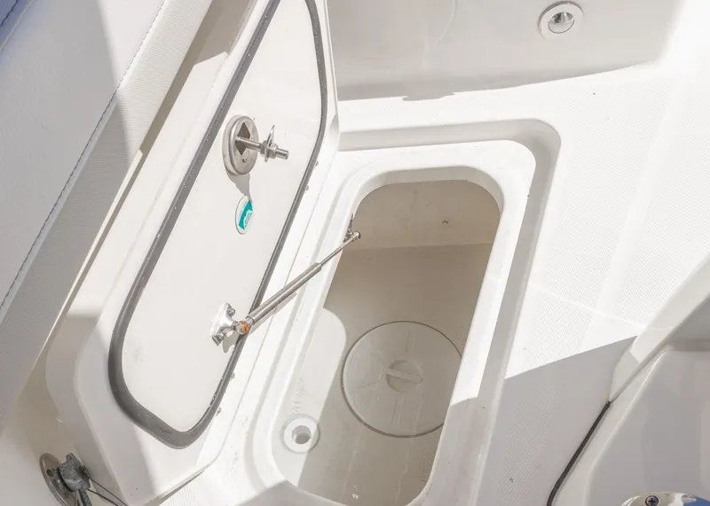 Slide: The Image of 2024 World Cat 260CC boat storage compartment with open hatch, showcasing interior details. - 25