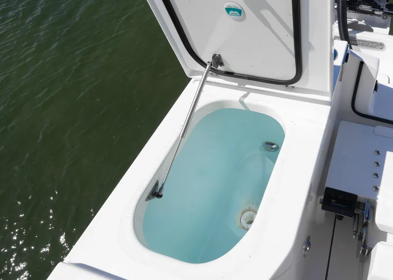 Slide: The Image of Livewell on 2024 World Cat 260CC boat, open lid, filled with water. - 30
