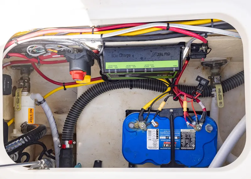 Slide: The Image of 2024 World Cat 260CC boat battery compartment with wiring and components. - 31