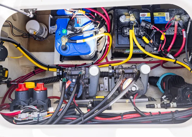 Slide: The Image of 2024 World Cat 260CC boat battery compartment with wiring and components. - 32