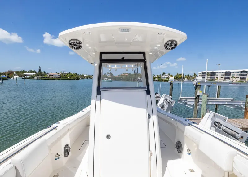 Slide: The Image of 2024 World Cat 260CC boat on calm water, showcasing sleek design and spacious deck. - 8