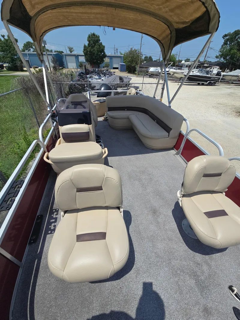 Slide: The Image of 2019 Sun Tracker Bass Buggy 18 DLX pontoon boat with beige seating and canopy. - 5