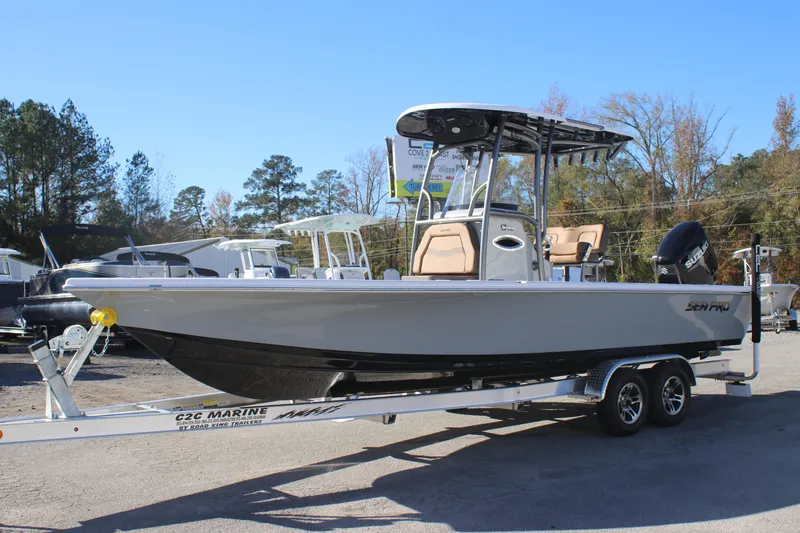 Slide: The Image of 2025 Sea Pro 250 Bay boat on trailer, outdoors, clear sky background. - 1