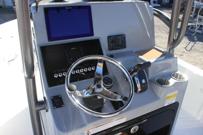 Slide: The Image of 2025 Sea Pro 250 Bay boat dashboard with steering wheel and control panel. - 10