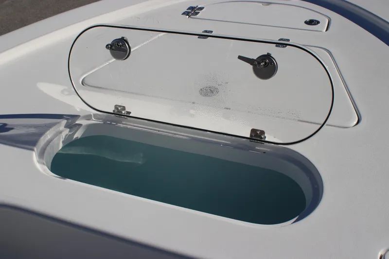 Slide: The Image of 2025 Sea Pro 250 Bay boat livewell with open lid, showcasing interior water storage. - 12