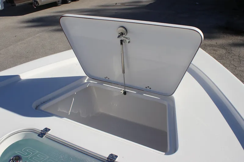 Slide: The Image of Open storage compartment on 2025 Sea Pro 250 Bay boat, showcasing spacious interior. - 14