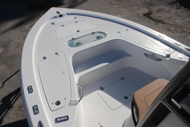 Slide: The Image of 2025 Sea Pro 250 Bay boat deck with storage compartments and seating. - 15