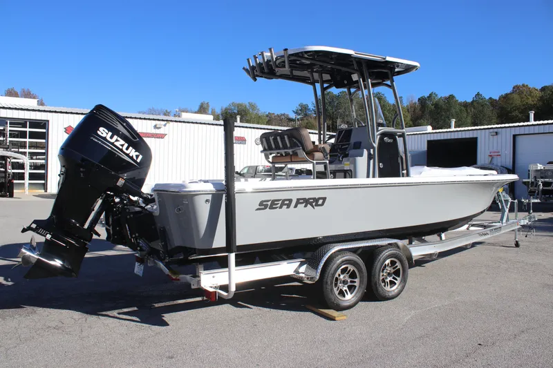 Slide: The Image of 2025 Sea Pro 250 Bay boat on trailer with Suzuki outboard motor. - 2